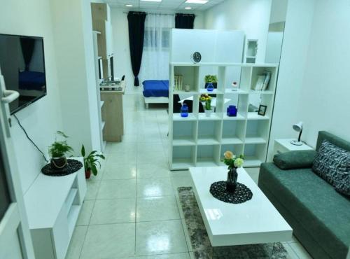 a living room with a couch and a table at Charming Sinj Town Studio Apartments in Sinj