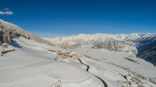 a view of a snowy mountain with mountains in the background at Panoramahotel Watles in Malles Venosta