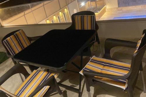 a black table and two chairs in a room at Private Pool - Relax Chalet Deadsea in Amman