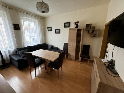 a living room with a table and a couch at Apartment 5 in Gera