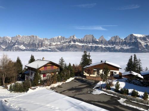 an aerial view of a house in the snow with mountains at Resort Walensee 45 in Unterterzen