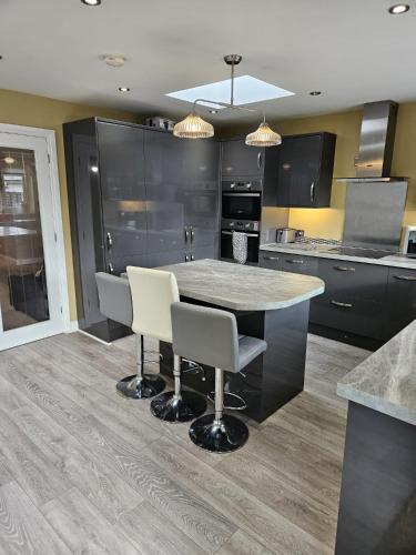 a kitchen with a table and chairs in it at Large Bungalow to sleep up to 8 in Slough