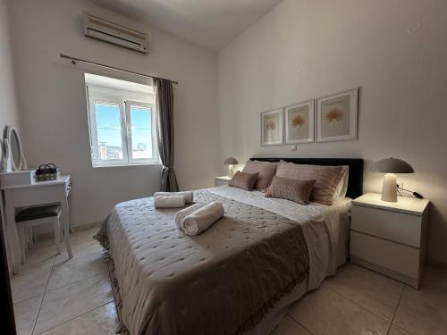 a bedroom with a bed with two pillows on it at Nick & Alex, Beautiful Village Apartment in Míthoi