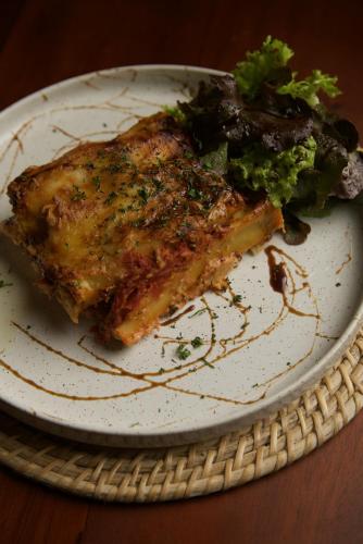 a plate with a piece of meat and broccoli on it at Daffodil Restaurant & Holiday Resort in Unawatuna