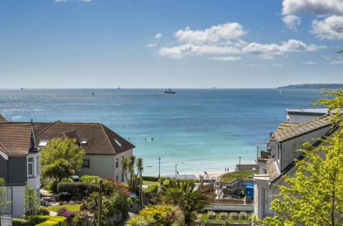 a view of a beach and the ocean with houses at Bosanneth in Falmouth