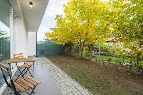 a patio with a table and chairs and a fence at Vila Magurele 4 in Măgurele