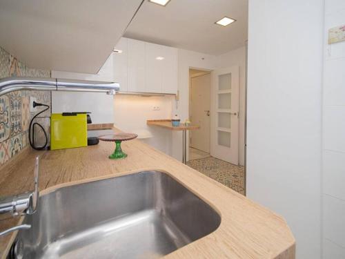 a kitchen with a stainless steel sink in a kitchen at SibsSanlucar Calma - Centro y Playa - Nuevo in Sanlúcar de Barrameda