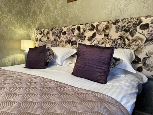 a bed with two pillows on it in a room at Winteringham Fields in Winteringham
