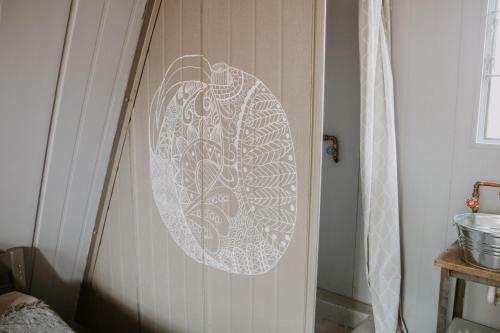a door with a stenciled design on it at White Linen Guesthouse in Tierpoort