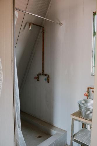 a bathroom with a sink and a shower in a room at White Linen Guesthouse in Tierpoort