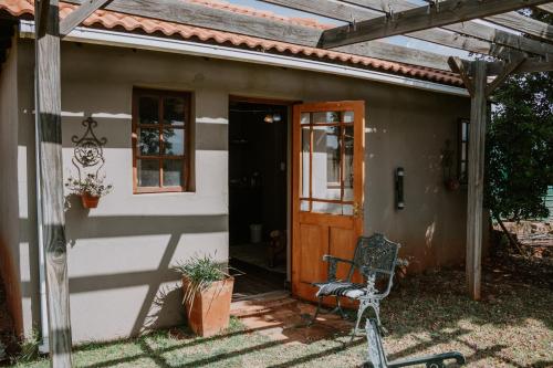 a bike parked outside of a house with a door at White Linen Guesthouse in Tierpoort