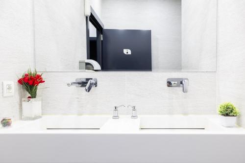 a bathroom with two sinks and a mirror at Hotel Beyond in Izmir