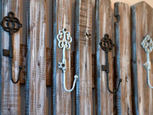 a bunch of wooden doors with iron handles at Apartman Vulcano in Zvolen