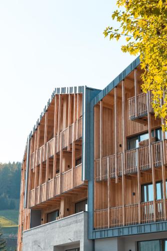 a building with balconies on the side of it at mySHH in Vigo di Fassa