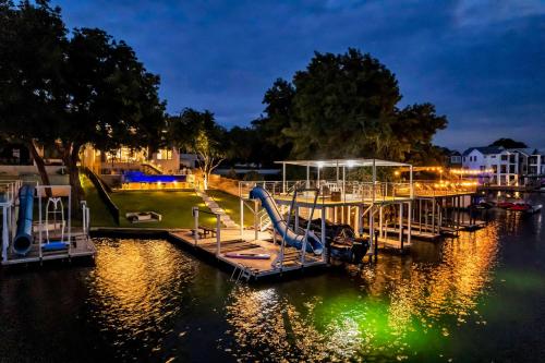 a dock with a slide and a playground on the water at Lakeshore Retreat with Concierge Services in Kingsland