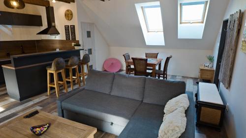 a living room with a couch and a kitchen at Apartman Vulcano in Zvolen