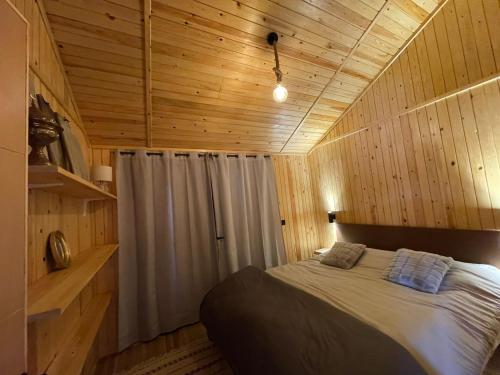 a bedroom with a bed in a wooden cabin at Scandinavian Chalet in the Atlas Mountains - Ifrane in Ifrane
