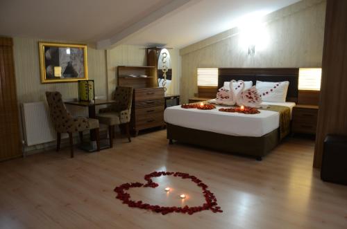 a bedroom with a bed with a heart on the floor at Gumus Palace Hotel in Istanbul
