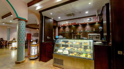 a bakery with a display case filled with pastries at Dar es Salaam Serena Hotel in Dar es Salaam