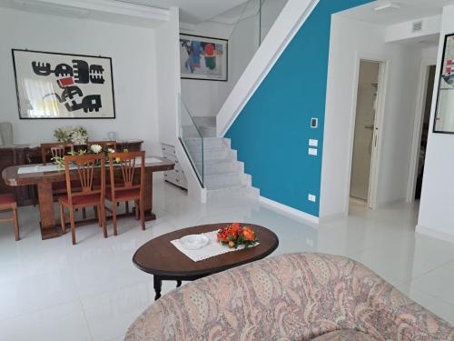 a living room with a table and a dining room at Villa La Blanca in Pellaro