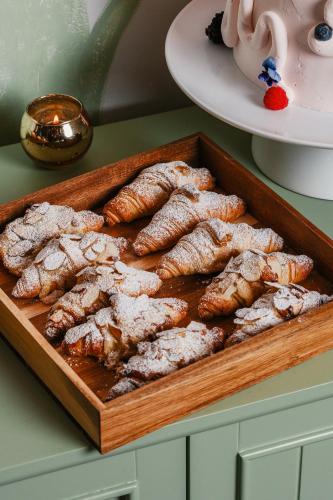 a wooden tray of fried food on a table at Casa Faena Miami Beach in Miami Beach