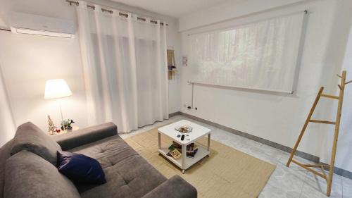 a living room with a couch and a table at The Whale Beach House in Atouguia da Baleia