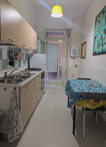 a kitchen with a sink and a table in it at Nei pressi del mare in Termoli