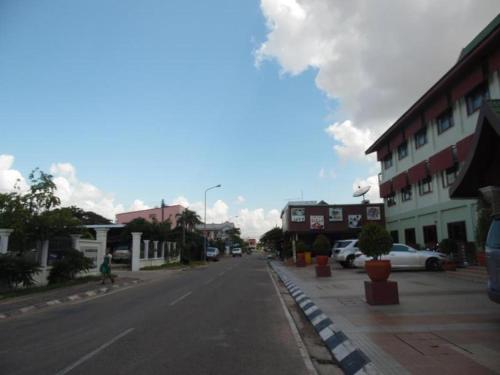 an empty street in a small town with buildings at Hungheuang Hotel in Savannakhet