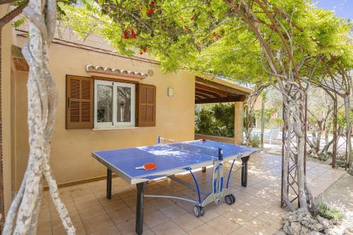 a blue ping pong table in front of a house at Villa Biel in Pollença