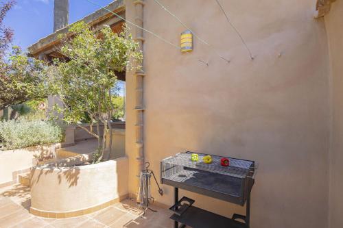 a wall with a table and a light on it at Villa Biel in Pollença