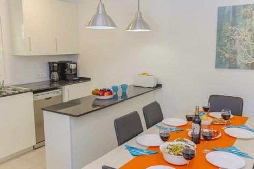 a kitchen with a table with plates and bowls of food at Villa Biel in Pollença