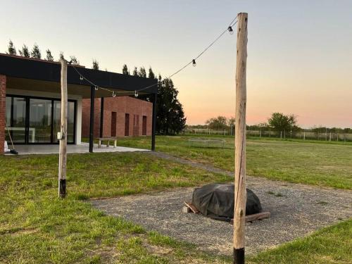 a turtle laying on the ground next to a pole at Casa de diseño en Chacras de la Trinidad in Cañuelas
