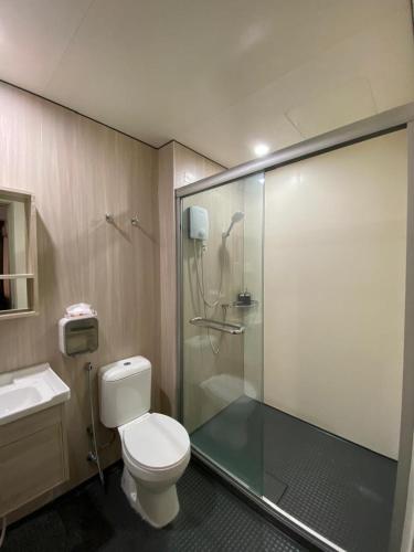 a bathroom with a toilet and a glass shower at Studio with Rooftop Pool at Youth City Nilai by D'KAY HOMES, near USIM KLIA in Nilai