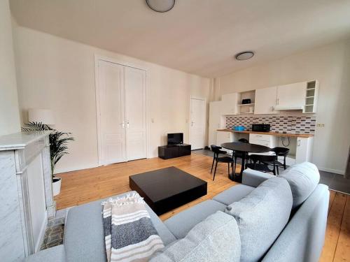 a living room with a couch and a table at La Suite Alice in Brussels