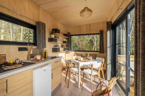a kitchen and dining room of a tiny house at Slow Village Saint-Cybranet - Périgord in Saint-Cybranet