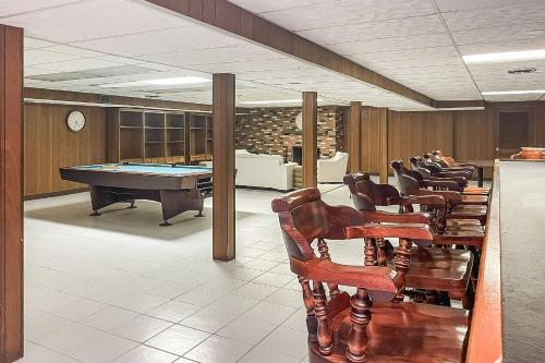 a conference room with a pool table and chairs at Akasa in Stratford