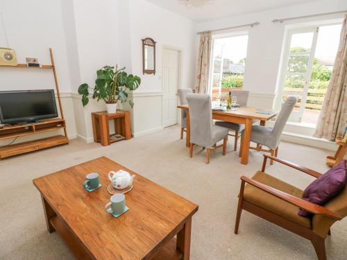 a living room with a table and a tv at John Duftons Barn in Cockermouth