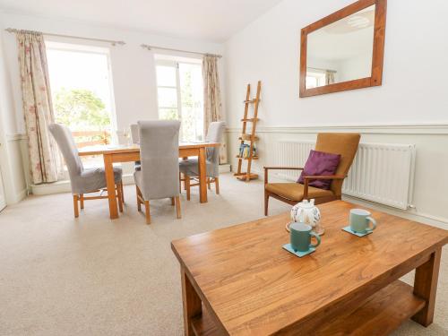 a living room with a wooden table and chairs at John Duftons Barn in Cockermouth