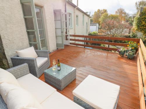 a patio with a couch and chairs on a deck at John Duftons Barn in Cockermouth