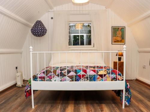 a bedroom with a bed with a quilt on it at Ballybeg Pod 5 in Arklow