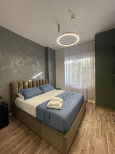 a bedroom with a bed with towels on it at Peaky Hotel in Durrës