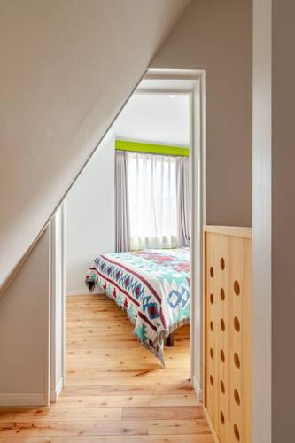 a bedroom with a bed and a window at Sakura House in Nagano
