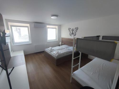 a room with two bunk beds and a ladder at apartmánový dom rodiny BÖJTÖS Patince in Virthova Pustatina