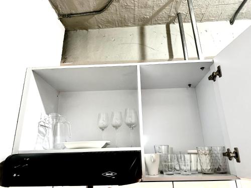 a kitchen with a counter with a sink and utensils at Apartamento en Chapinero in Bogotá