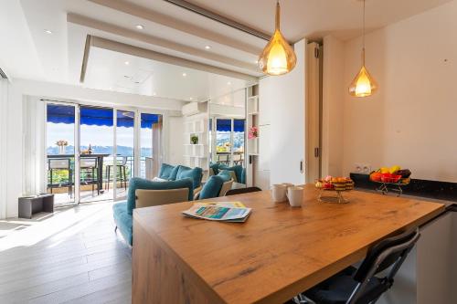 Il comprend une cuisine et un salon avec une grande table en bois. dans l'établissement Esterel AP4431 By Riviera Holiday Homes, à Villefranche-sur-Mer
