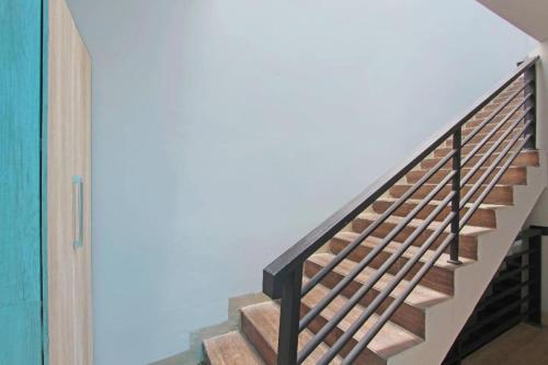 a staircase in a house with a green door at OYO 91531 Dreamstay 2 in Semarang