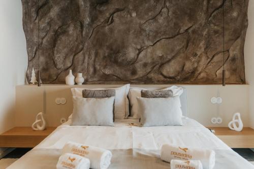 a bedroom with a large rock wall above a bed at Pousadela Village & Spa in Vieira do Minho