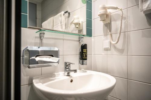 a bathroom with a sink and a phone on the wall at Dresdner Tor Süd in Wilsdruff
