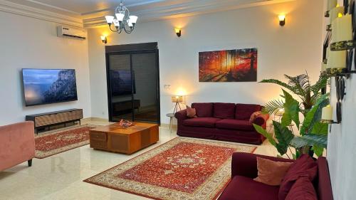 a living room with two couches and a table at Res'Zac in Rufisque