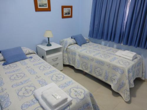 A bed or beds in a room at Departamento FORCHE 3ra Bajada al mar